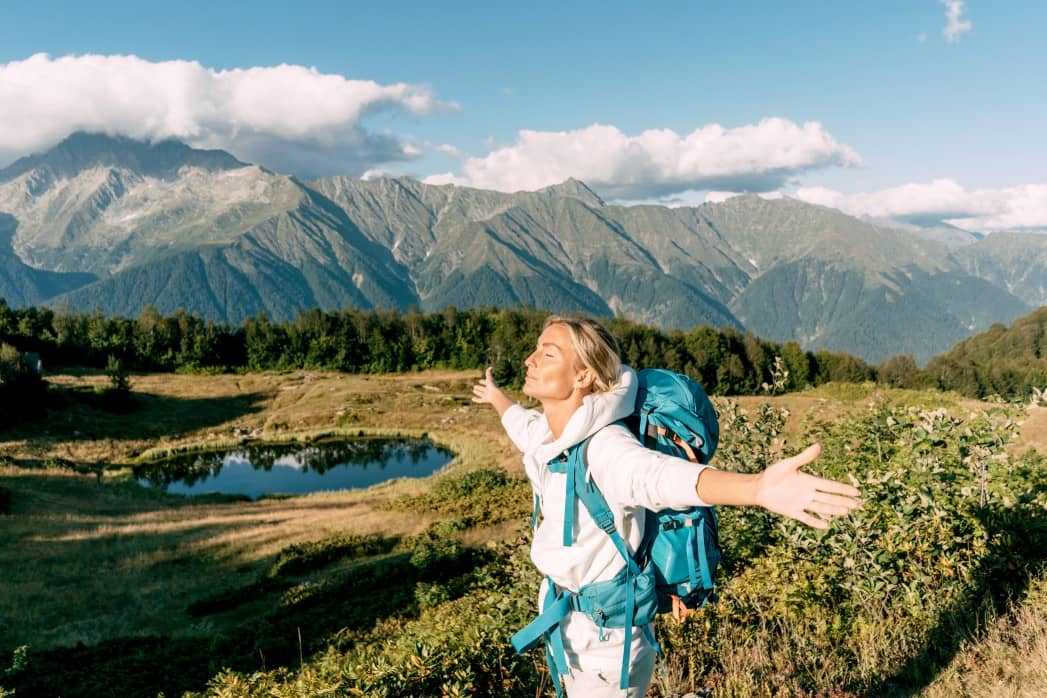 Woman soaking up the sunlight on a hike